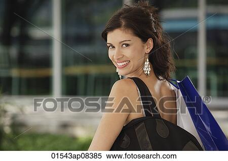 Woman with shoulder bag, looking at camera View Large Photo Image Stock Photography - Woman with shoulder bag, looking at camera. Fotosearch