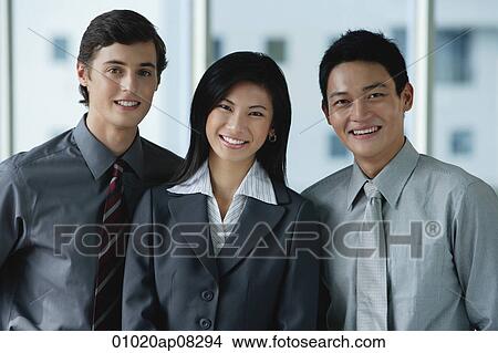 Work colleagues smile at the camera together View Large Photo Image Picture - Work colleagues smile at the camera together. Fotosearch