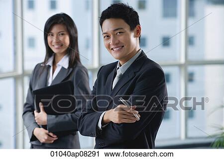 Work colleagues smile at the camera together View Large Photo Image Stock Image - Work colleagues smile at the camera together. Fotosearch