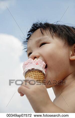 Young boy eating an ice cream cone View Large Photo Image Stock Image - Young boy eating an ice cream cone. Fotosearch