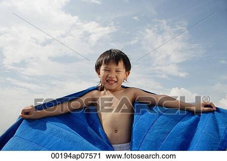 Young boy on beach with blue towel flying behind him View Large Photo Image Stock Image - Young boy on beach with blue towel flying behind him. Fotosearch