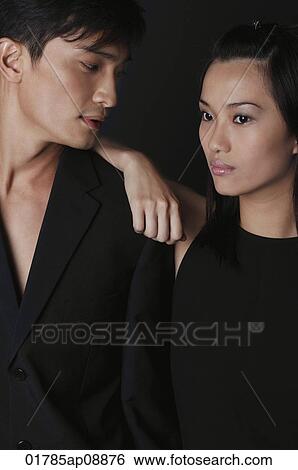Young couple leaning on each other View Large Photo Image Stock Photograph - Young couple leaning on each other. Fotosearch