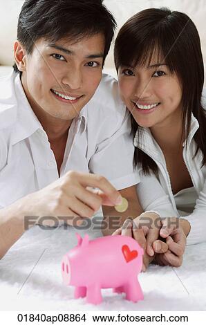 Young couple with piggy bank View Large Photo Image Picture - Young couple with piggy bank. Fotosearch