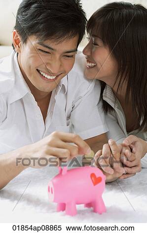 Young couple with piggy bank View Large Photo Image Stock Photography - Young couple with piggy bank. Fotosearch