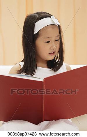 young female child reading book, sitting on couch View Large Photo Image Stock Image - young female child reading book, sitting on couch. Fotosearch