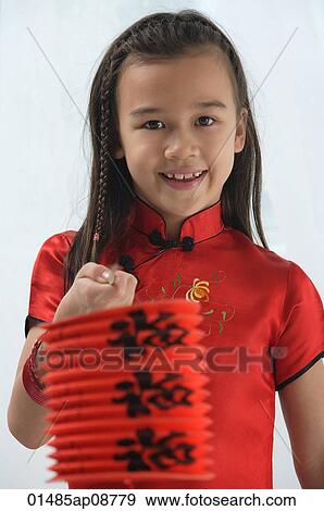 Young girl in traditional Chinese dress holding red lantern and looking at camera View Large Photo Image Stock Photo - Young girl in traditional Chinese dress holding red lantern and looking at camera. Fotosearch