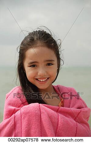 Young girl on beach wrapped in pink towel, smiling View Large Photo Image Stock Photo - Young girl on beach wrapped in pink towel, smiling. Fotosearch