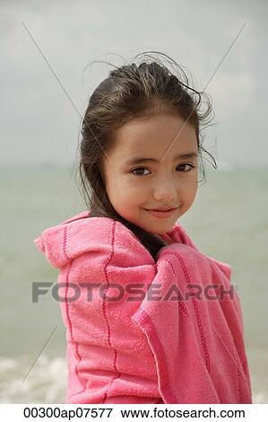 Young girl on beach wrapped in pink towel View Large Photo Image Stock Photo - Young girl on beach wrapped in pink towel. Fotosearch