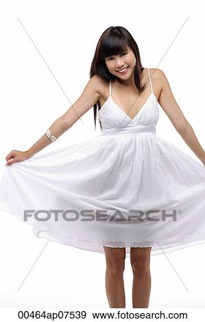Young girl wearing white dress, smiling View Large Photo Image Stock Photo - Young girl wearing white dress, smiling. Fotosearch