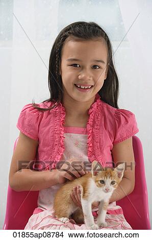 Picture - Young girl with kitten on her lap. Fotosearch