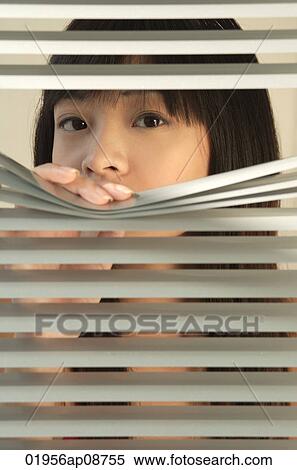 Young woman behind Venetian blinds View Large Photo Image Stock Photography - Young woman behind Venetian blinds. Fotosearch