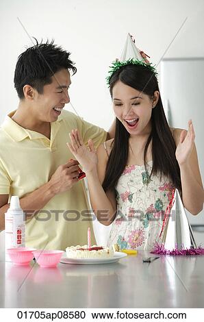 Young woman being surprised with birthday cake View Large Photo Image Stock Image - Young woman being surprised with birthday cake. Fotosearch