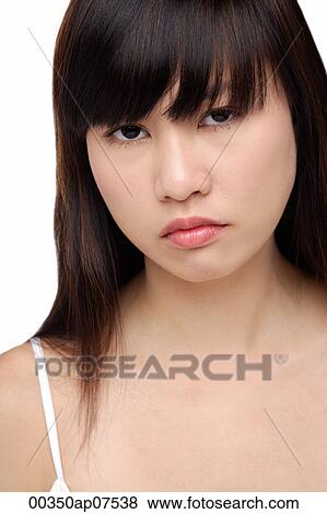 Young woman frowning, portrait View Large Photo Image Stock Photo - Young woman frowning, portrait. Fotosearch