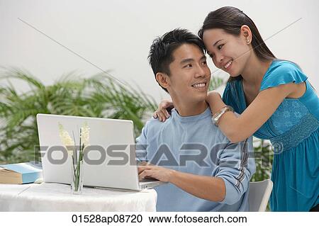 Young woman leaning on shoulder of man at the computer View Large Photo Image Stock Image - Young woman leaning on shoulder of man at the computer. Fotosearch