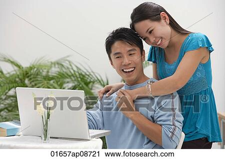 Young woman leaning on shoulder of man at the computer View Large Photo Image Stock Image - Young woman leaning on shoulder of man at the computer. Fotosearch