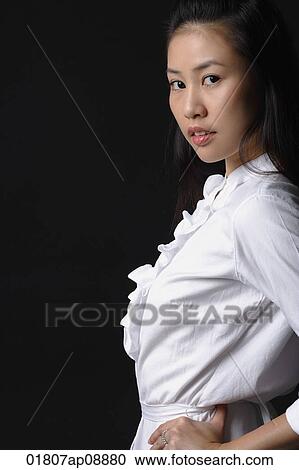 Young woman looking at camera View Large Photo Image Stock Image - Young woman looking at camera. Fotosearch