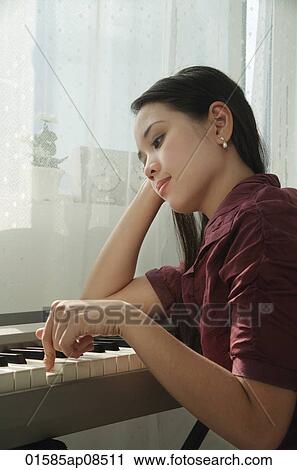 Young woman playing keyboard View Large Photo Image Stock Image - Young woman playing keyboard. Fotosearch