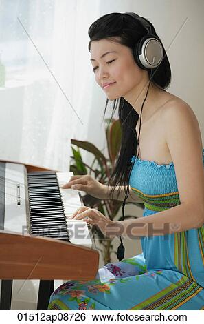 Young woman playing keyboard View Large Photo Image Stock Photograph - Young woman playing keyboard. Fotosearch