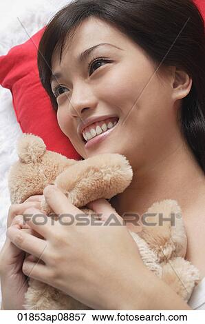 Young woman playing with teddy View Large Photo Image Stock Photo - Young woman playing with teddy. Fotosearch