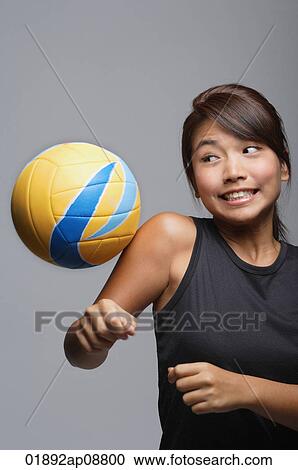 Young woman playing with volleyball View Large Photo Image Stock Image - Young woman playing with volleyball. Fotosearch