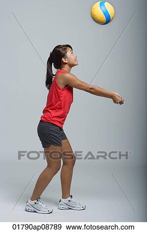 Young woman playing with volleyball View Large Photo Image Stock Photo - Young woman playing with volleyball. Fotosearch