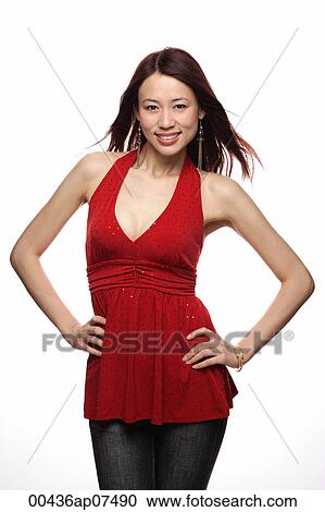 Young woman smiling at camera, hands on hip View Large Photo Image Stock Image - Young woman smiling at camera, hands on hip. Fotosearch