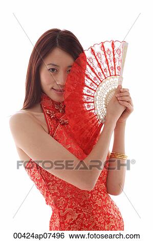 Stock Photograph - Young woman wearing cheongsam and holding Chinese fan. Fotosearch