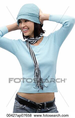 Young woman wearing hat and scarf, hands on head View Large Photo Image Stock Photo - Young woman wearing hat and scarf, hands on head. Fotosearch