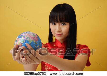 Young woman wearing red cheongsam and holding globe in the palm of her hands View Large Photo Image Stock Image - Young woman wearing red cheongsam and holding globe in the palm of her hands. Fotosearch