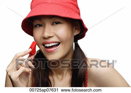 young woman wearing red hat and holding whistle, looking at camera, smiling View Large Photo Image Stock Image - young woman wearing red hat and holding whistle, looking at camera, smiling. Fotosearch
