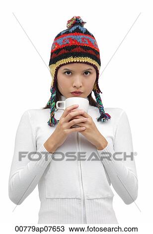 Young woman wearing winter hat and holding mug of hot chocolate View Large Photo Image Stock Image - Young woman wearing winter hat and holding mug of hot chocolate. Fotosearch