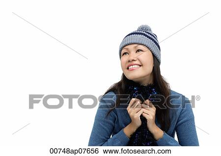 Young woman wearing winter hat and scarf, smiling View Large Photo Image Stock Photograph - Young woman wearing winter hat and scarf, smiling. Fotosearch
