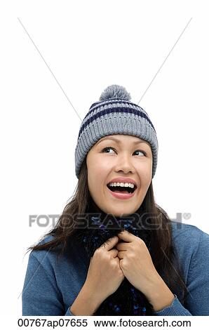 Young woman wearing winter hat and scarf, smiling and looking up View Large Photo Image Stock Photography - Young woman wearing winter hat and scarf, smiling and looking up. Fotosearch