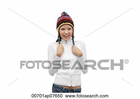 Young woman wearing winter hat, smiling at camera View Large Photo Image Stock Image - Young woman wearing winter hat, smiling at camera. Fotosearch