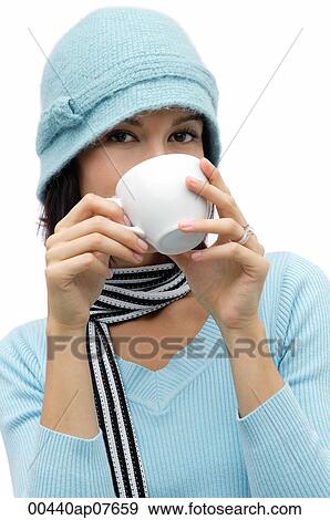 Young woman wearing wool hat and scarf, drinking hot chocolate View Large Photo Image Stock Photo - Young woman wearing wool hat and scarf, drinking hot chocolate. Fotosearch