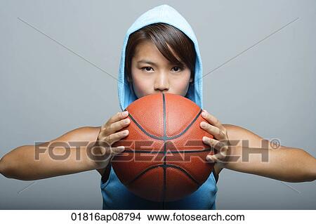 Young woman with basketball looking at camera View Large Photo Image Picture - Young woman with basketball looking at camera. Fotosearch