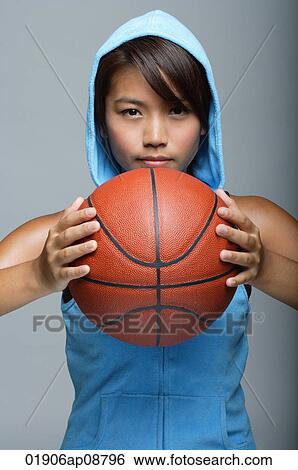 Young woman with basketball looking at camera View Large Photo Image Stock Photograph - Young woman with basketball looking at camera. Fotosearch
