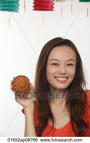 Young woman with Chinese lantern smiling at camera View Large Photo Image Stock Photograph - Young woman with Chinese lantern smiling at camera. Fotosearch