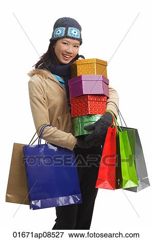 Young woman with gift boxes and shopping bags, smiling at camera View Large Photo Image Stock Photo - Young woman with gift boxes and shopping bags, smiling at camera. Fotosearch