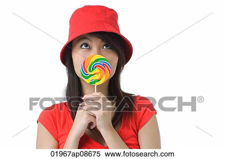 Young woman with lollipop looking up View Large Photo Image Stock Photography - Young woman with lollipop looking up. Fotosearch