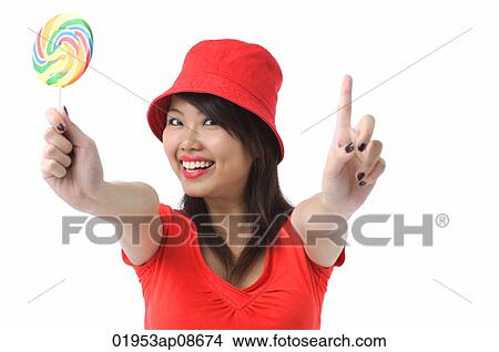 Young woman with lollipop smiling at camera View Large Photo Image Picture - Young woman with lollipop smiling at camera. Fotosearch