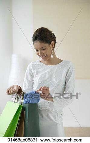 Young woman with shopping bags View Large Photo Image Stock Image - Young woman with shopping bags. Fotosearch