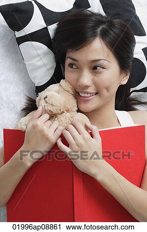 Young woman with teddy and book View Large Photo Image Stock Image - Young woman with teddy and book. Fotosearch