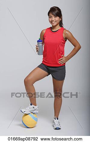 Young woman with volleyball smiling at camera View Large Photo Image Stock Image - Young woman with volleyball smiling at camera. Fotosearch