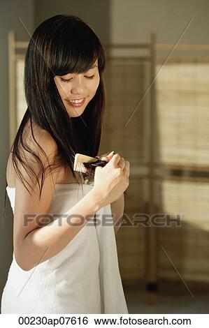 Young woman wrapped in white towel and combing hair with wooden comb View Large Photo Image Stock Photograph - Young woman wrapped in white towel and combing hair with wooden comb. Fotosearch