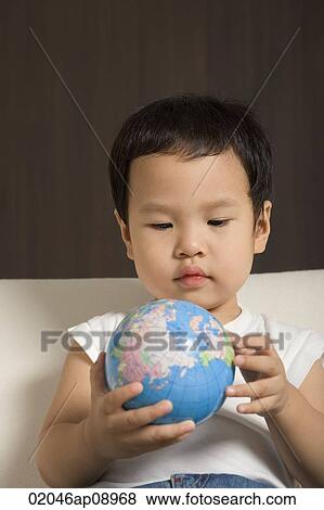Baby boy looking at globe View Large Photo Image Stock Photo - Baby boy looking at globe. Fotosearch
