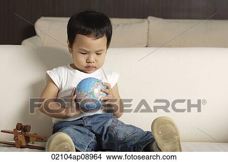 Baby boy playing with globe View Large Photo Image Picture - Baby boy playing with globe. Fotosearch