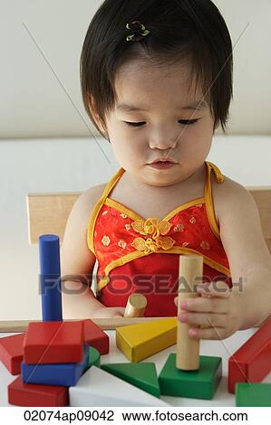 Baby girl playing with building blocks View Large Photo Image Stock Image - Baby girl playing with building blocks. Fotosearch
