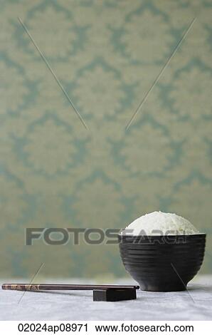Bowl of rice with chopsticks View Large Photo Image Stock Image - Bowl of rice with chopsticks. Fotosearch