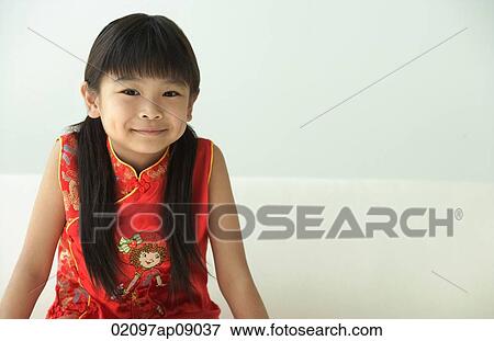 Girl in traditional clothes smiling at camera View Large Photo Image Stock Photo - Girl in traditional clothes smiling at camera. Fotosearch